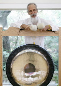 mehtab standing behind the gong