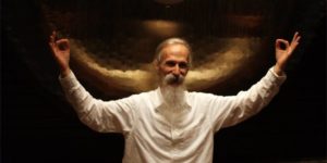 mehtab holding gyan mudra in front of the 84 in paiste gong