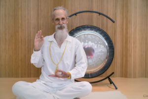 mehtab holding mudras with a gong - kundalini meditation retreat