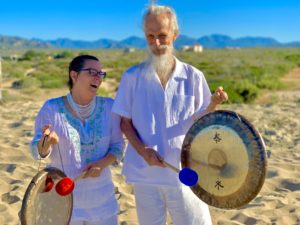 playing the gong on the beach