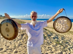 playing the gong on the beach