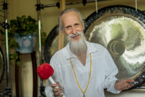 mehtab holding mallet in front of a gong