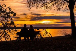 couple overlooking a lake at sunset